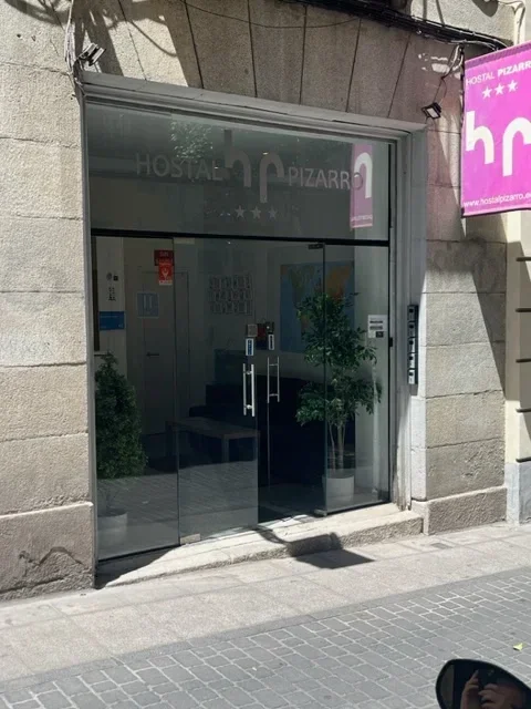 Hostal Pizarro street entrance in historic urban building