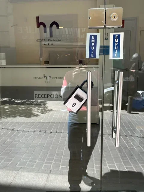 Glass reception door with metal handles